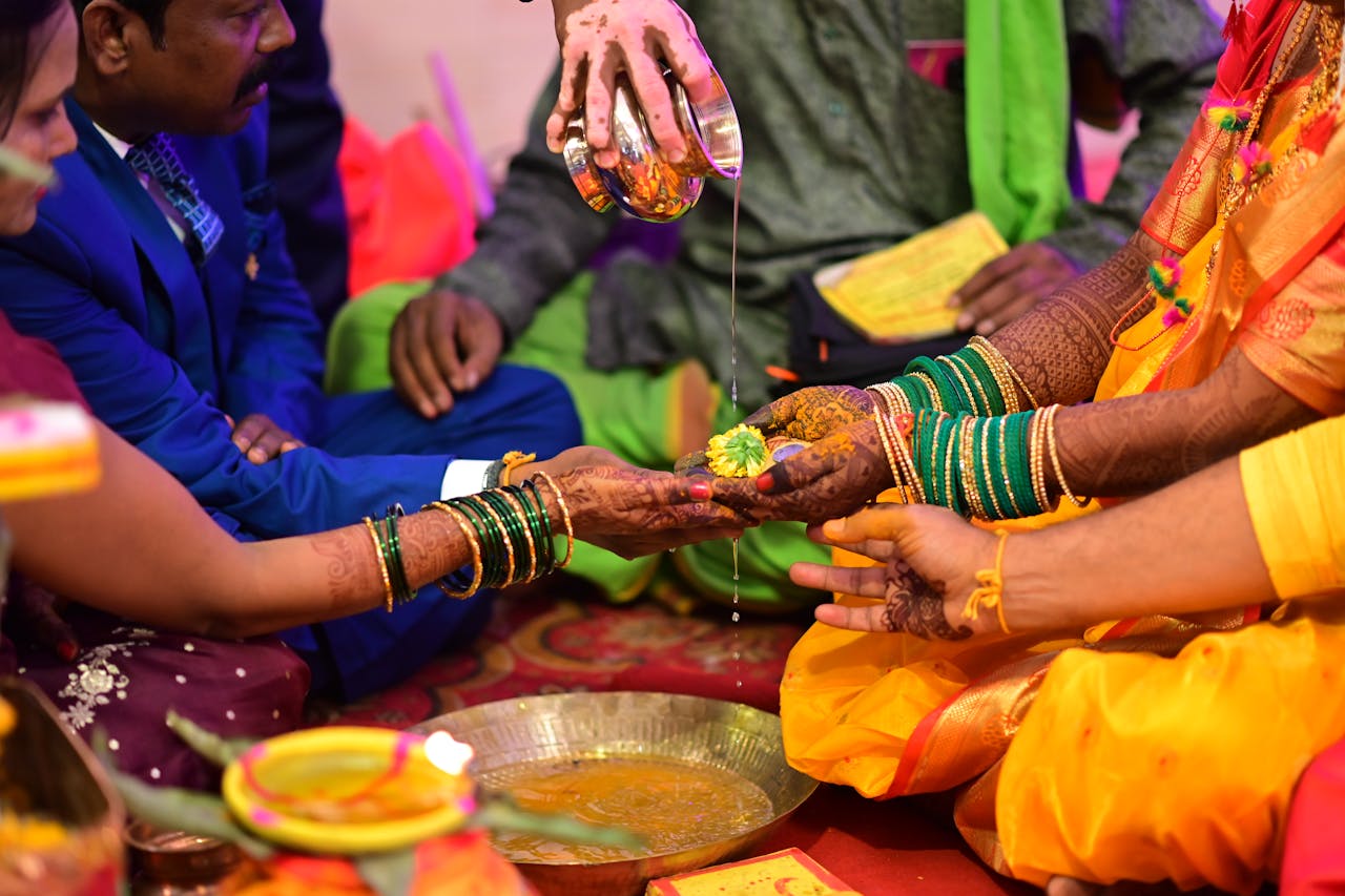 hero-img-02 Close-up of a vibrant Indian wedding ceremony with hands and rituals.