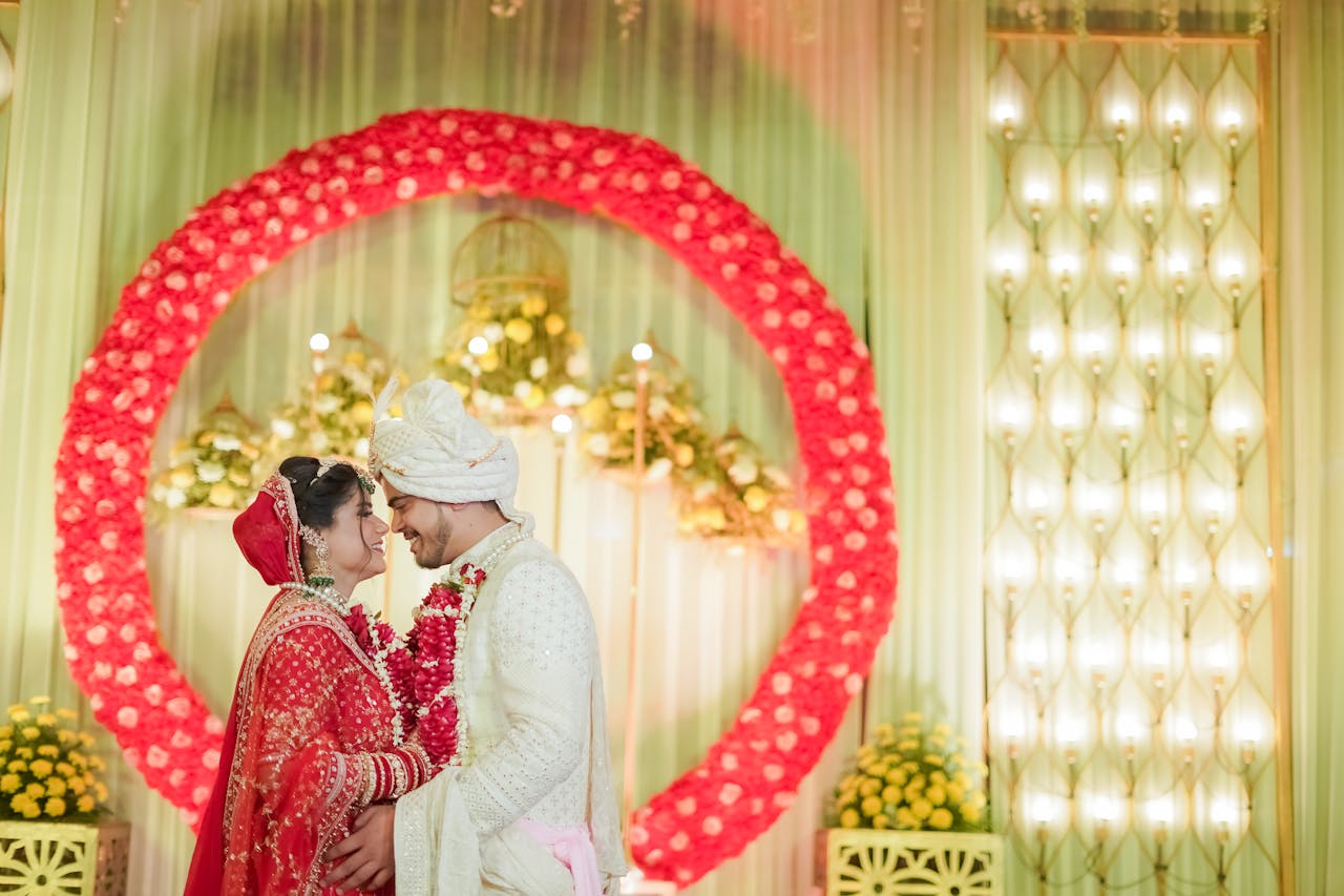 gallery-2 A vibrant Indian wedding in Delhi showcasing a bride and groom in traditional attire surrounded by floral decor.