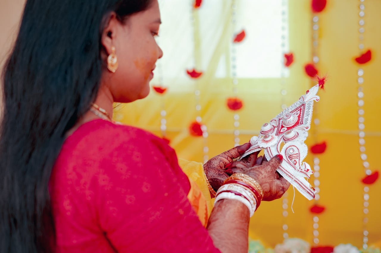gallery-5 A Bengali bride holding a traditional mukut during a wedding ceremony in Kolkata, India.